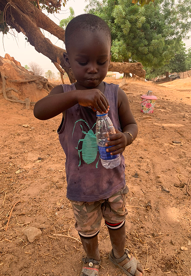 A child in Senegal drinking clean water