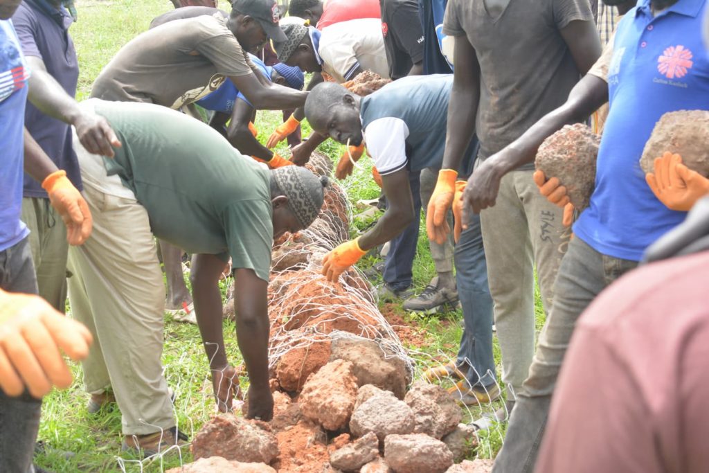 Community members constructing gabions in Senegal as a nature based solution