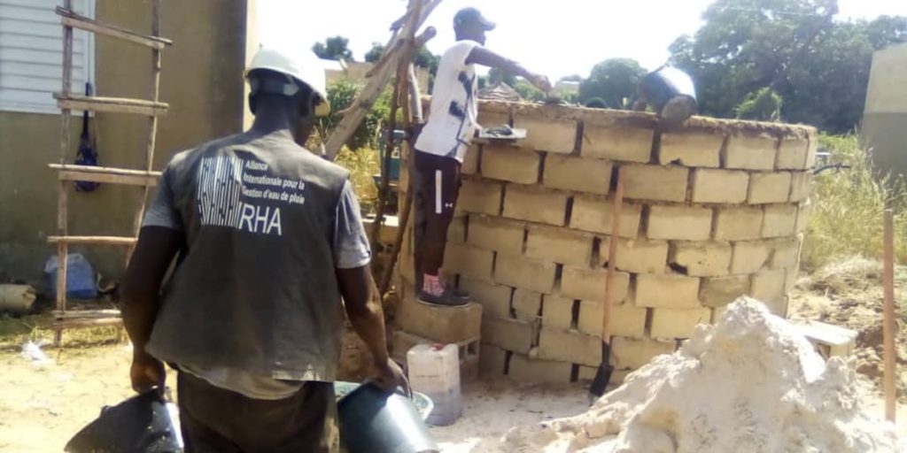 IRHA field partners building a rainwater storage tank in Senegal
